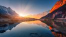 A winter sun rise with light illuminated on the mountains tops and its reflection on a lake in Nepal in January.