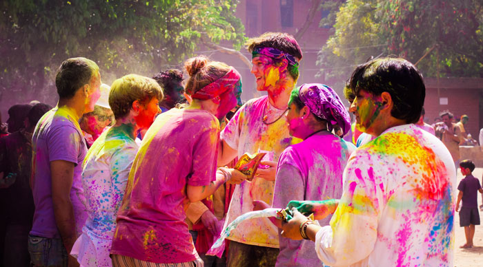 Tourist with students celebrating festival Holi