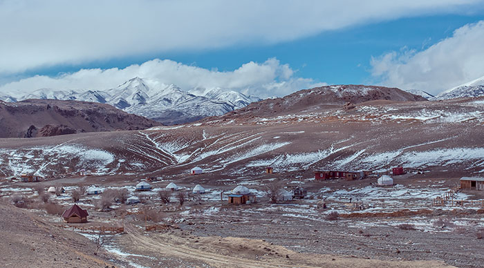 Camping in Mongolia with snow mountains surrounded in the background