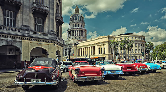 Old American cars in the parking in front of Havana