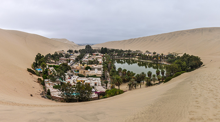 An oasis between the dunes of Huacachina in the coastal desert of Peru